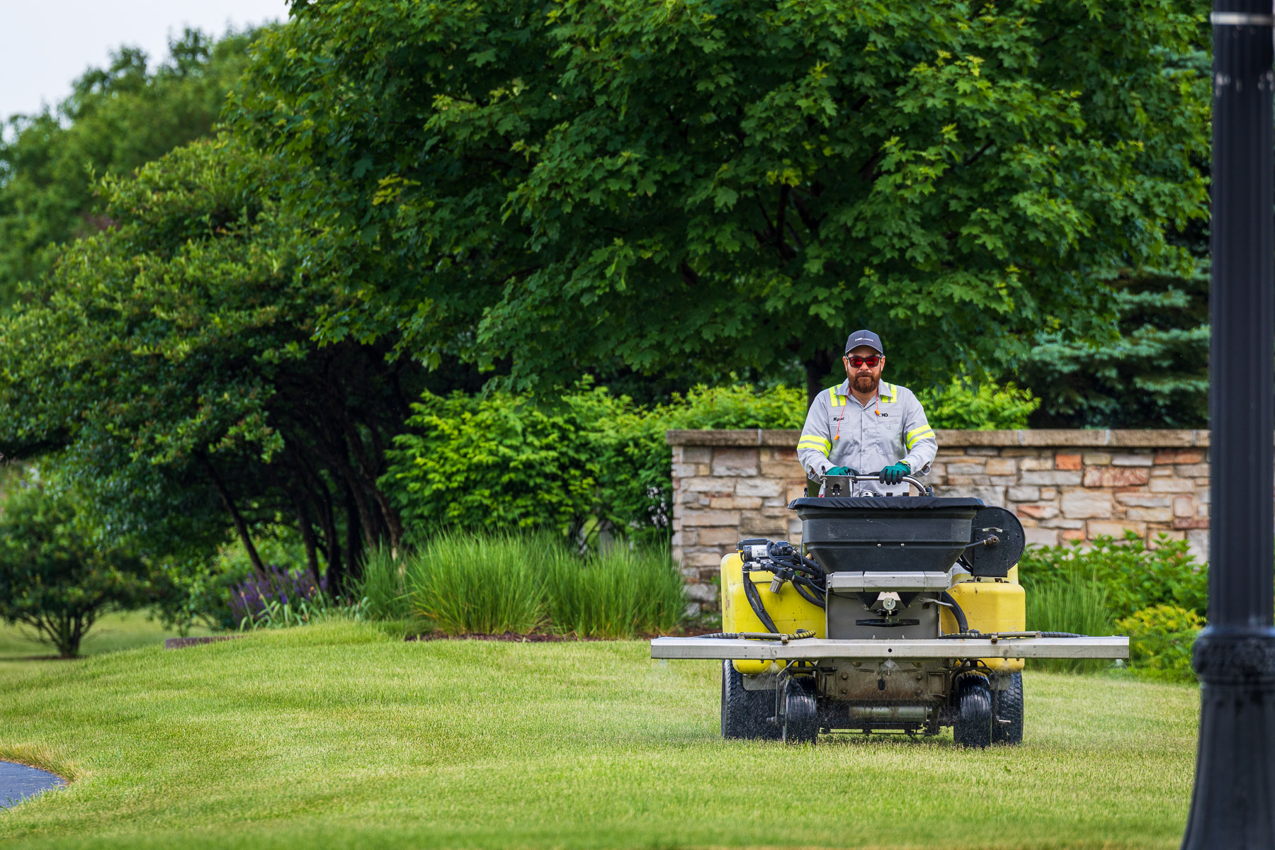 Commercial landscaping crew maintaining lawn at a West Virginia office park